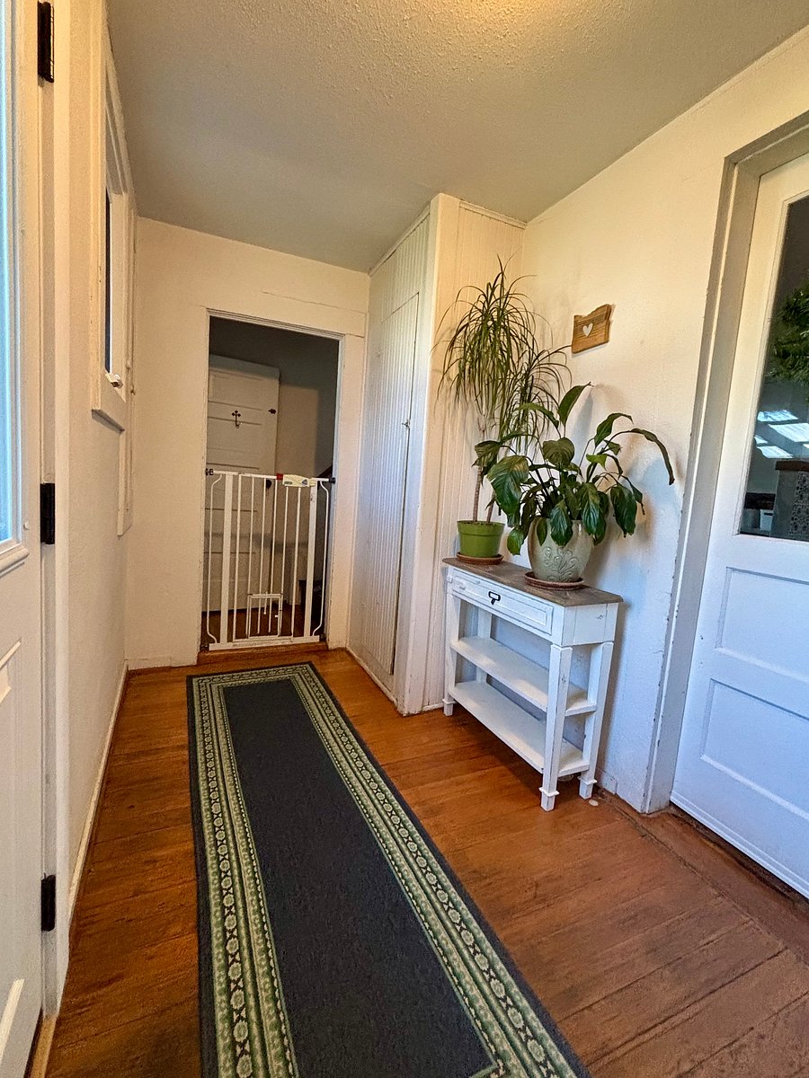 Another view of the semi-private entrance leading to your private suite upstairs and a shared half bath on the lower level. This mudroom and laundry area is separated from the rest of the house by another door and includes cleaning supplies, an iron, and a steamer.