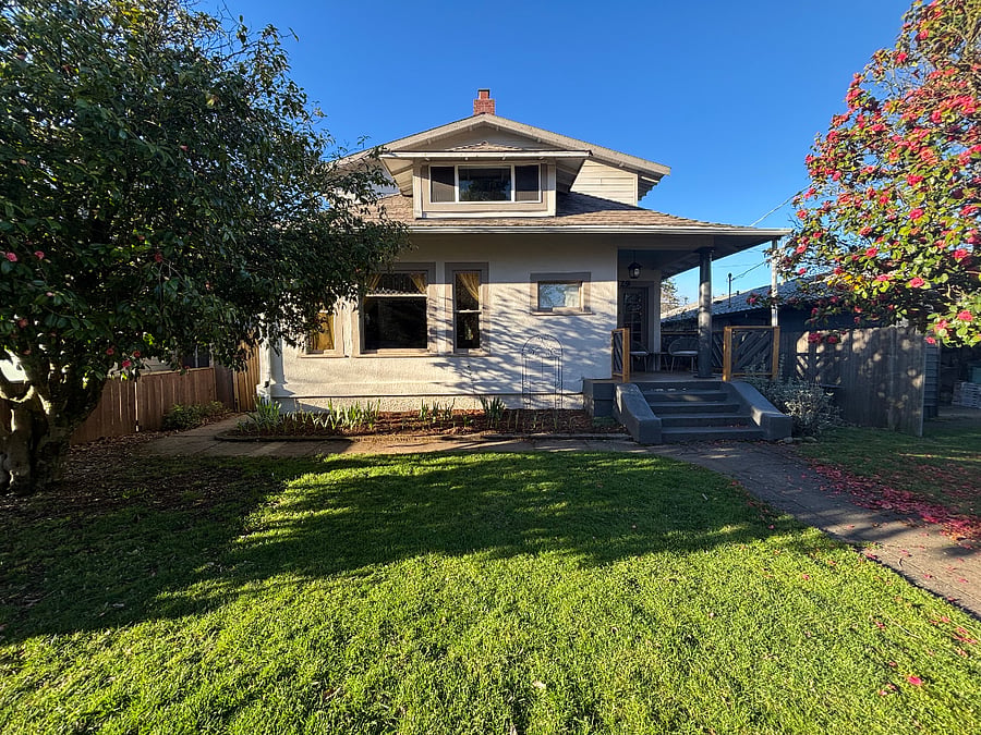 Front of house. The locked gate on the left side leads to the backyard and your semi-private back entrance.