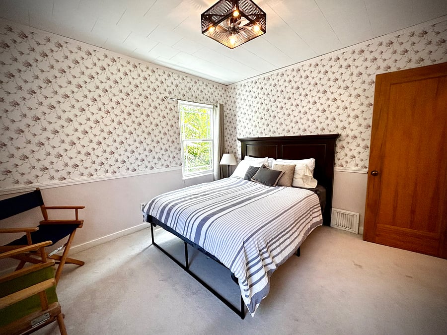 Downstairs queen bedroom with built in cabinet, drawers and closet.