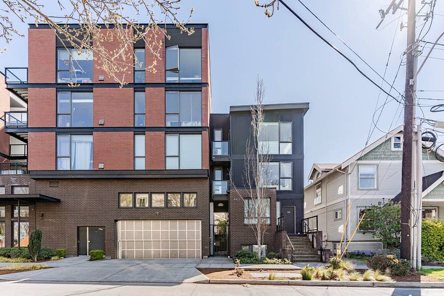 unit is the top floor of the small building with the black facade.