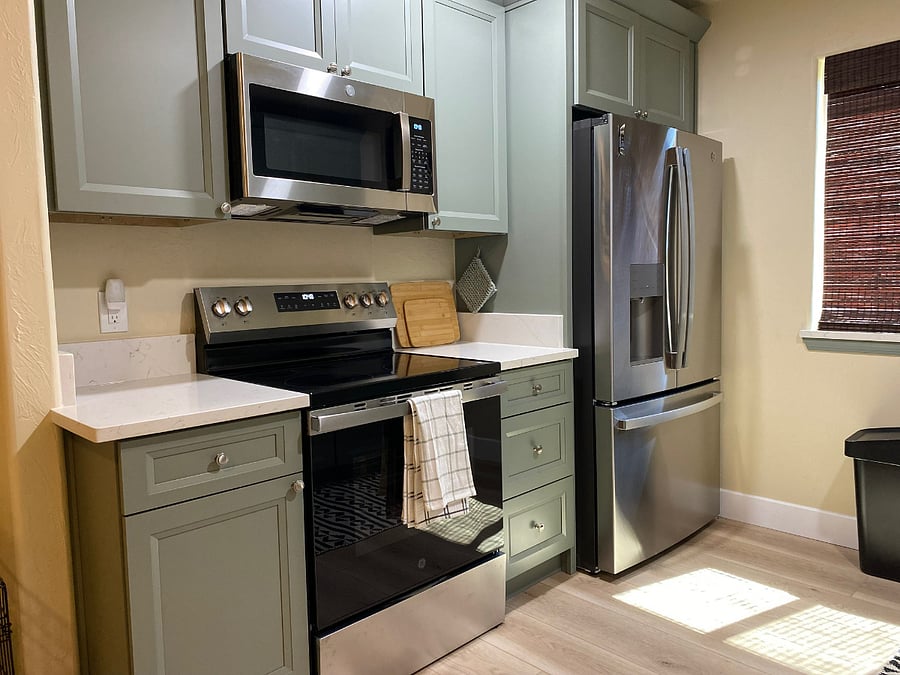Kitchen area, electric stove, refrigerator with ice and water dispenser