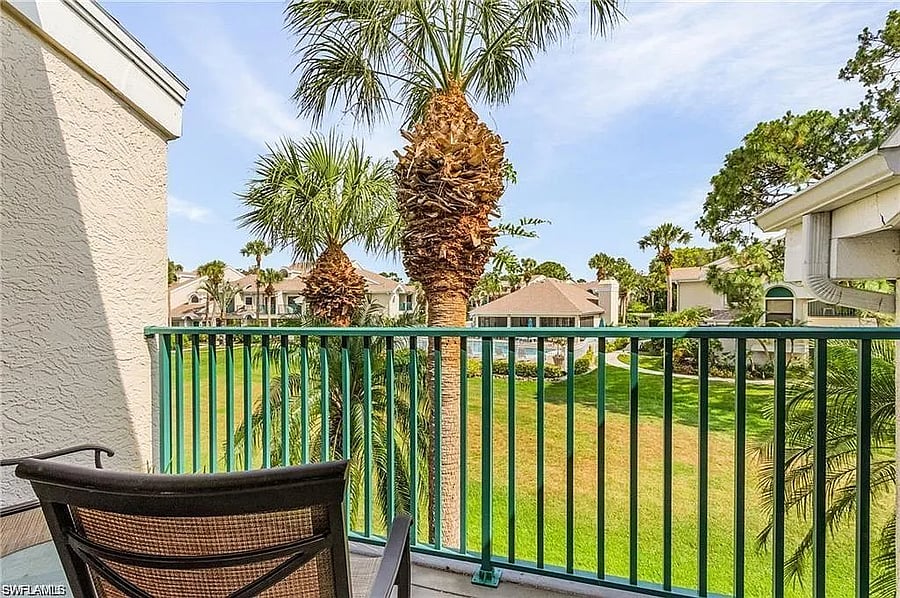 Balcony off main living area. View of the beautiful grounds and the pool. Unit is perfectly located within steps of the pool.