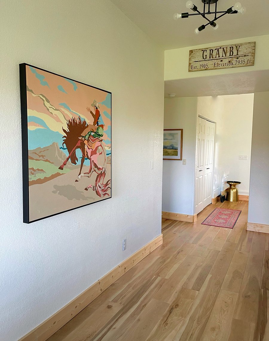 Artwork in the downstairs living room, and looking towards to stairwell and front door.