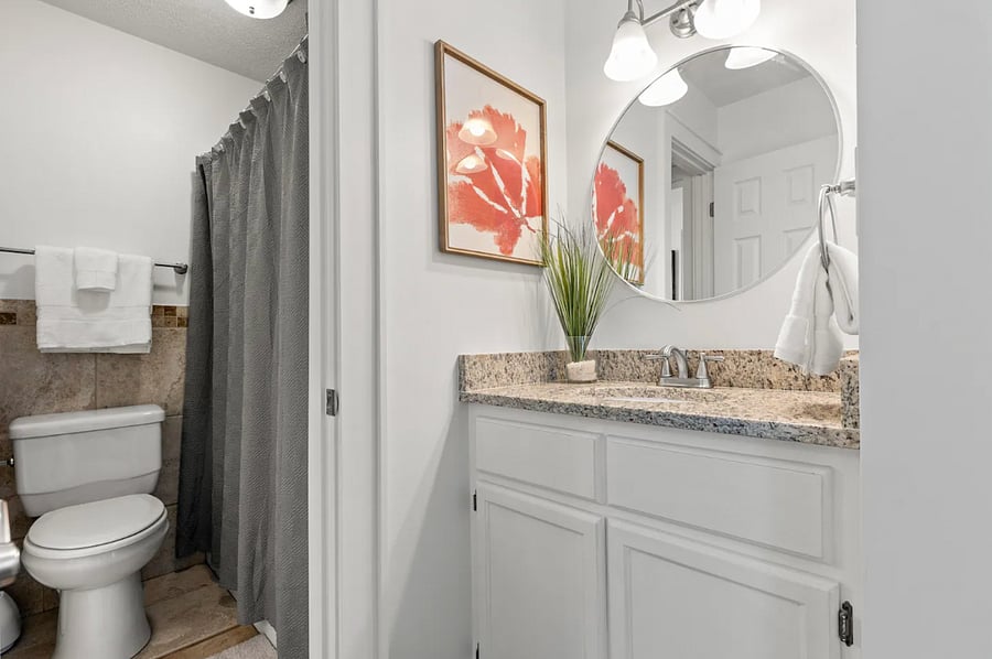 Private vanity in east-facing queen bedroom with connecting door to shared toilet and shower/tub.