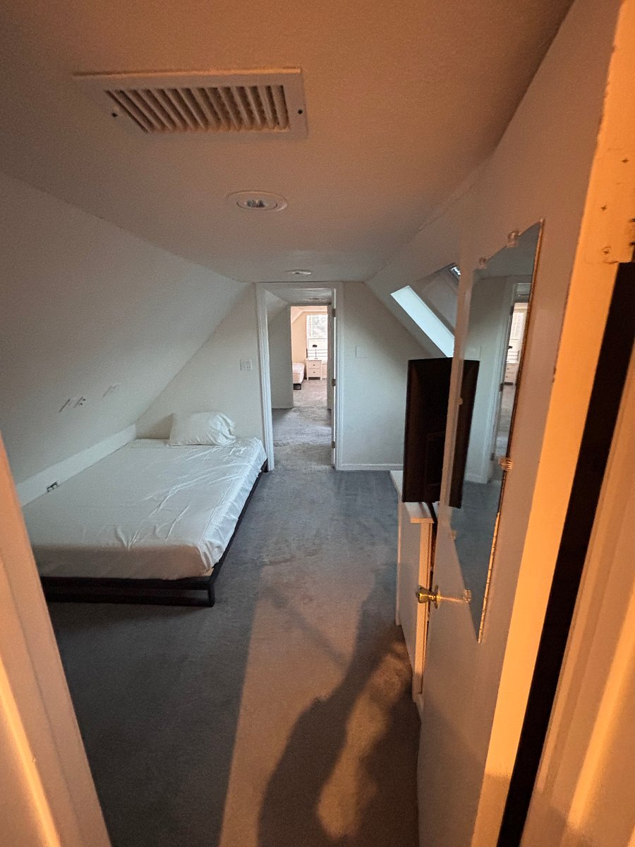 View from bath room to hallway with extra storage closets and office/private living room.