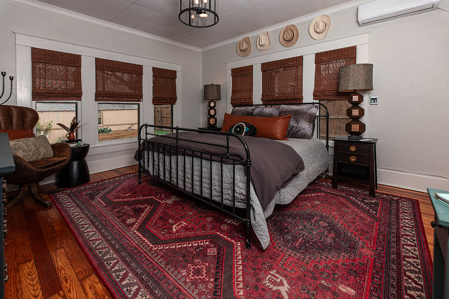 King- Size bed, Dresser, closet, hardwood floors, chair for sitting area.
