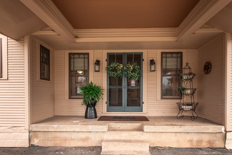 Side entry, double doors with screen, covered carport.