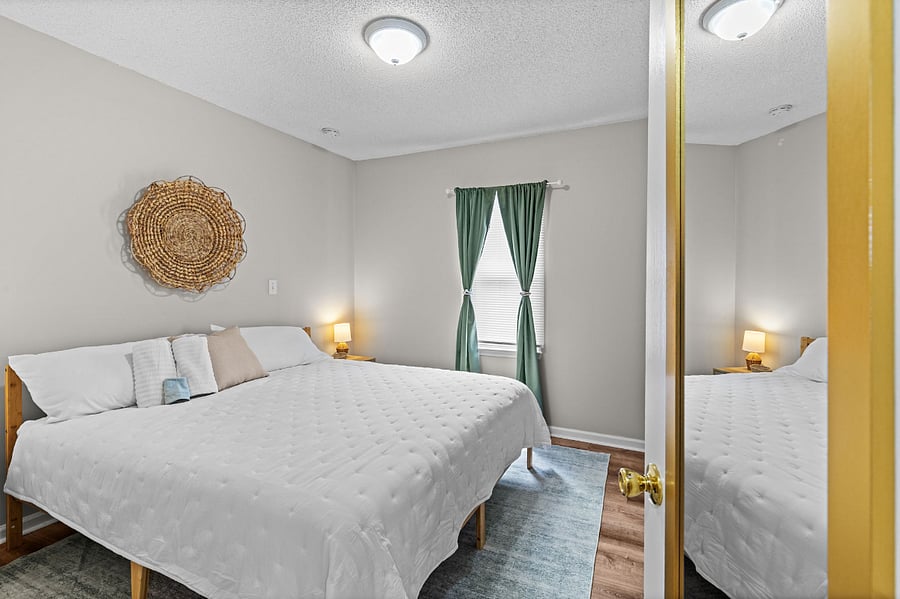 The primary bedroom offers a comfy night's sleep or daytime nap with a king size, hybrid mattress, and blackout curtains.