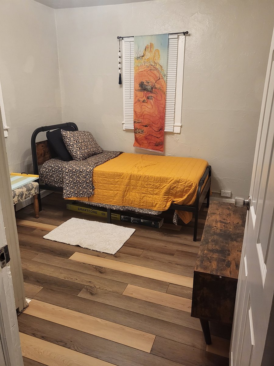 Guest bedroom with closet and lamp with charging capabilities.