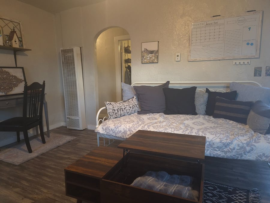 Daybed in living room for extra sleeping options. Coffee table has lift-top with storage.