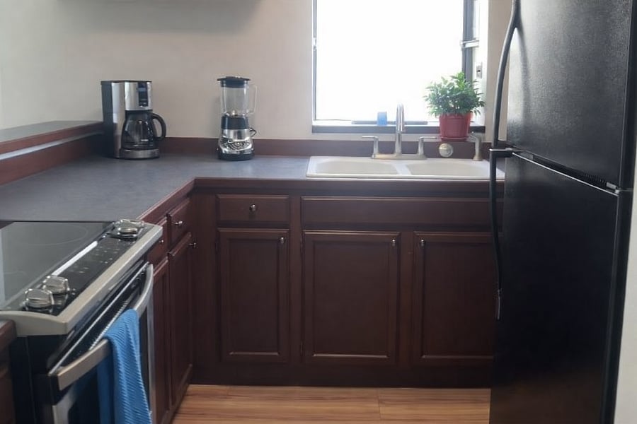 Kitchen with large window and shelf perfect for herbs and plants.