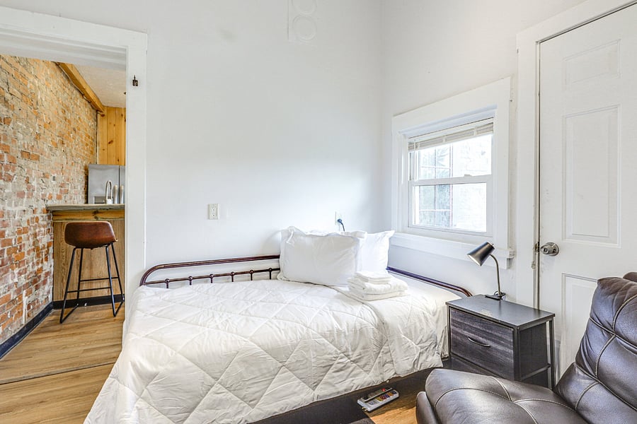 Private room with single twin bed and attached private bathroom.