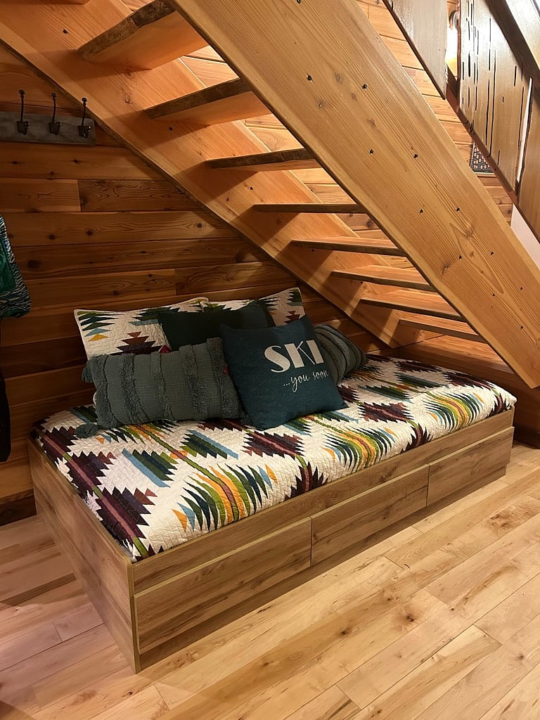 main floor day bed - adjacent to dining table and wood stove