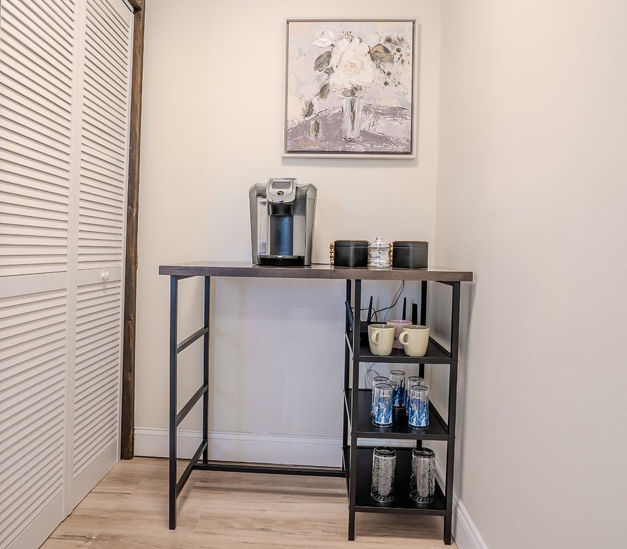 First floor living area with Smart TV, Sofa and arm chair, Coffee station that can be conveniently switched to working space.