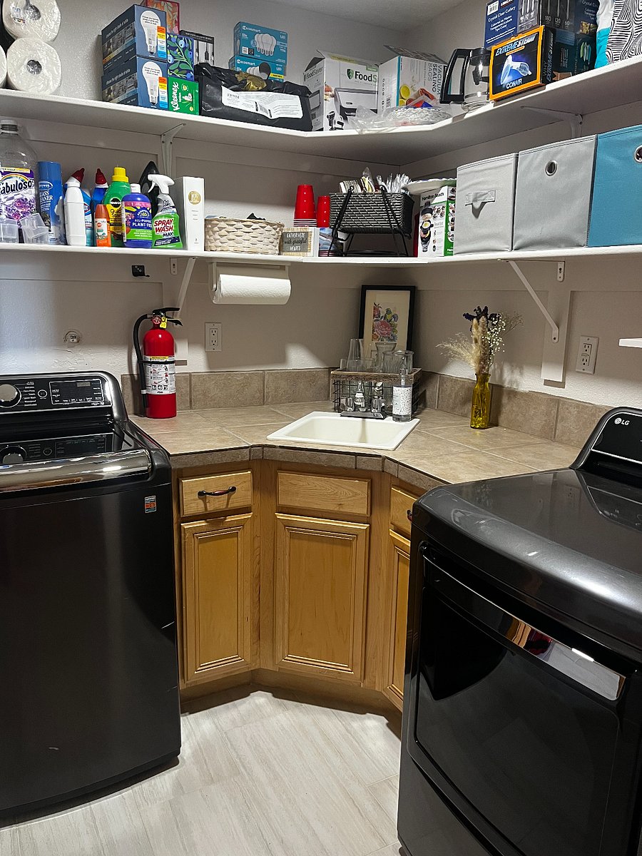 laundry room with steamer function on dryer to remove wrinkles