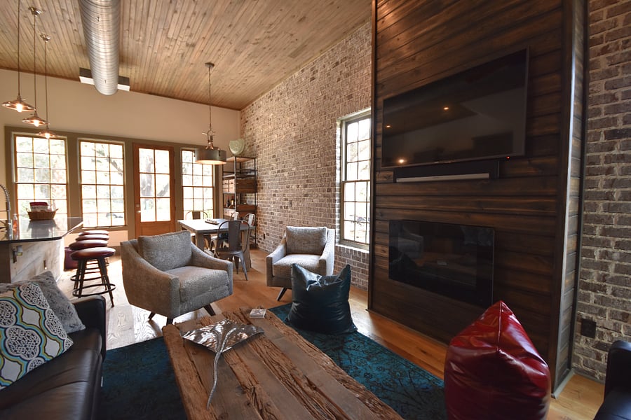 Looking from living room into kitchen/dining area.  Gas fireplace is below the TV.  