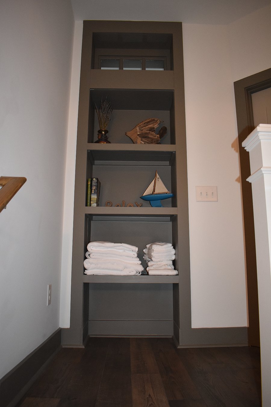 built in shelving at top of stairs.