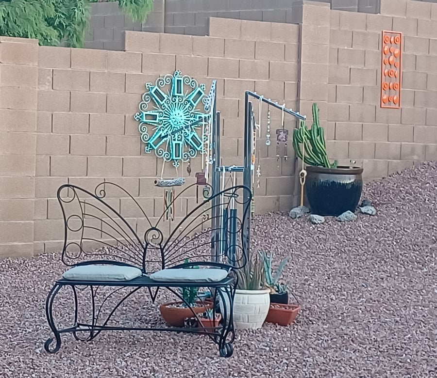 The back yard is artsy and colorful. A pleasant place to relax.