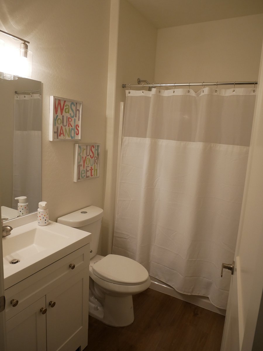 Common space bathroom with tub and shower. 