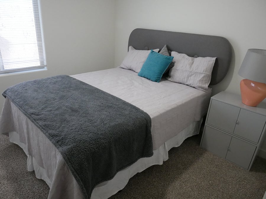 Second bedroom has a queen bed, night stand, ceiling fan and closet. 