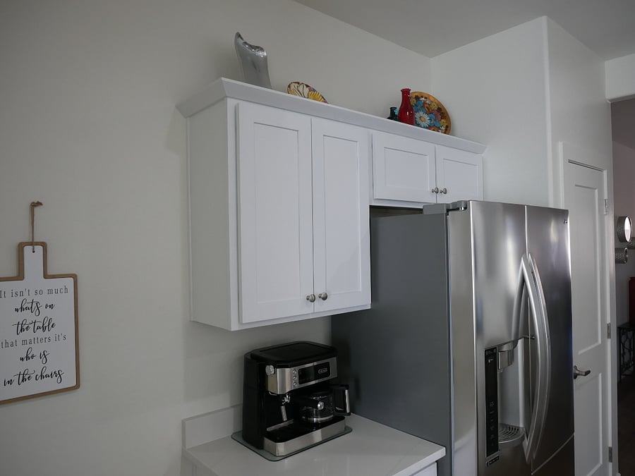 Cabinets are full of different types of dishware, cookware and bakeware. 