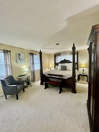 Upstairs Primary Suite with four-poster king bed