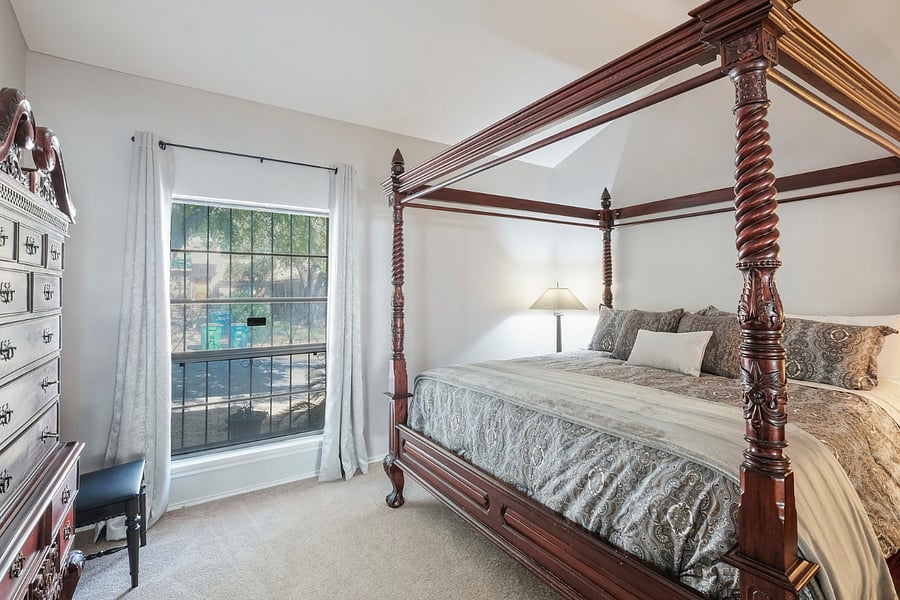 Master bedroom hosts a king size bed and opens to private bath with two sinks and tile shower