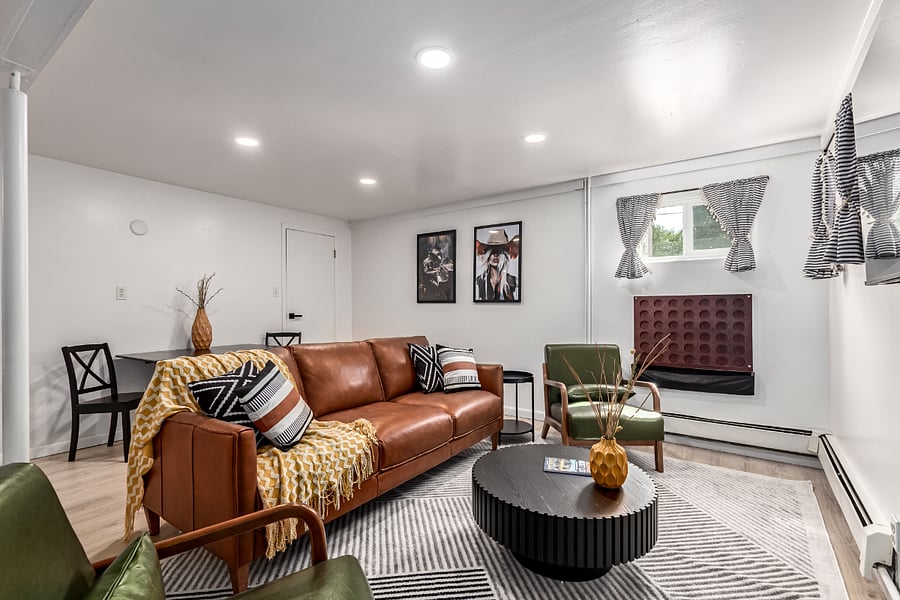 Cozy and stylish living room with Colorado-inspired art. Relax in a brand new genuine leather couch and comfy armchairs. Perfect for unwinding after work or enjoying downtime during your Colorado stay. 