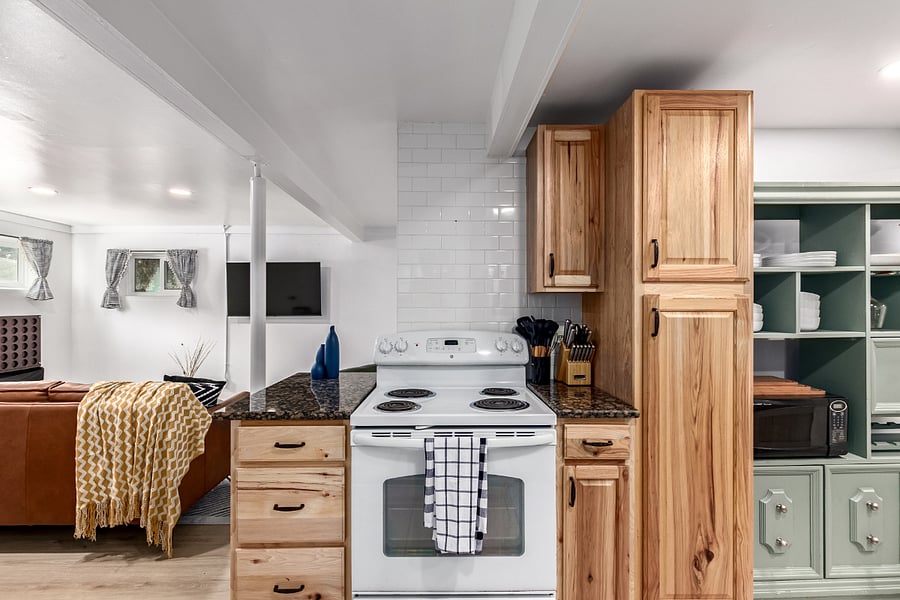Fully stocked kitchen- compact but complete! Features solid wood cabinets and all the essentials:  bakeware, utensils, Keurig, induction cookware, microwave, and more. Perfect for extended stays and home cooked meals. 