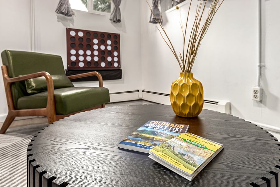 Explore Colorado like a local- brows the Colorado Bucket List book and nearby hiking map of Golden and Boulder, all set on a sturdy wood coffee table. Your adventure starts here!