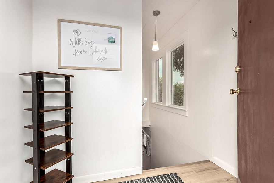 Welcoming Entryway- "With Love from Colorado" a convenience shoe rack, entry rug and private staircase down to the fully separate basement unit with its own entrance- no shared spaces!