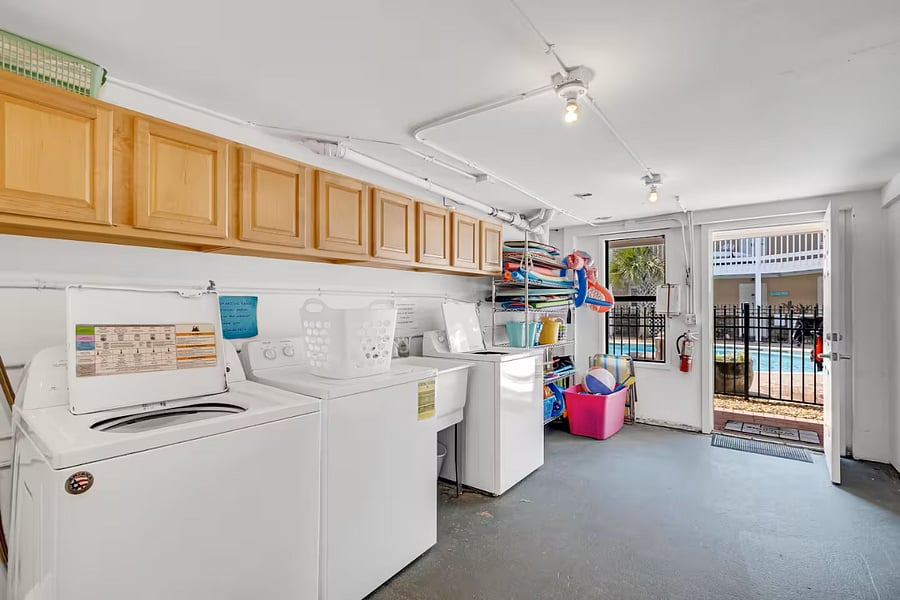 Free laundry room available, equipped with pool toys for tenant use.