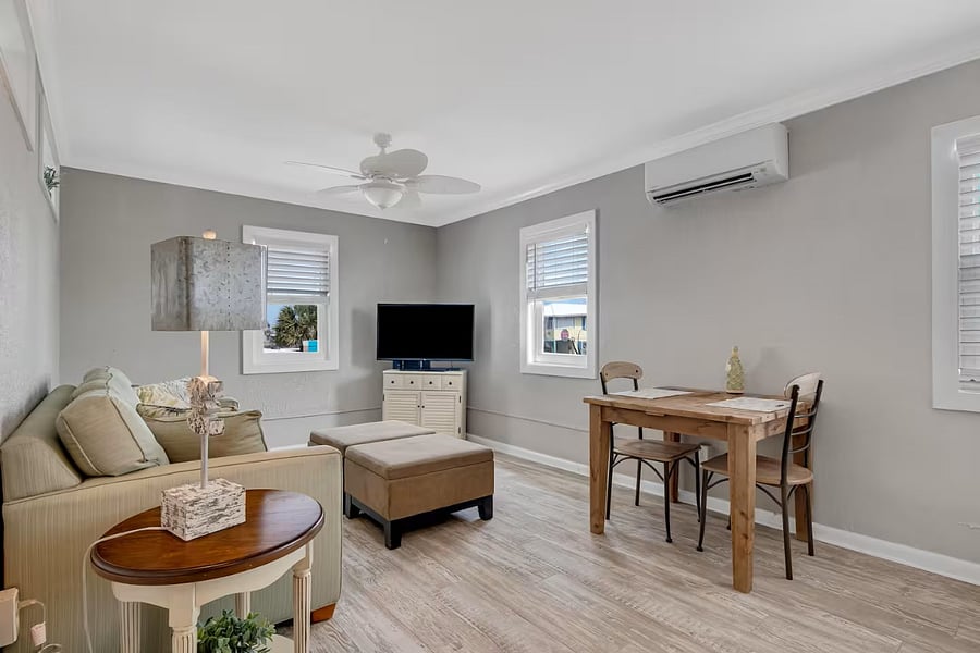 Spacious living room featuring a mini-split system for both AC and heat, a smart TV, high-speed internet, and a pull-out sofaperfect for relaxing and unwinding. Large windows offer scenic views of the ocean and A1A.