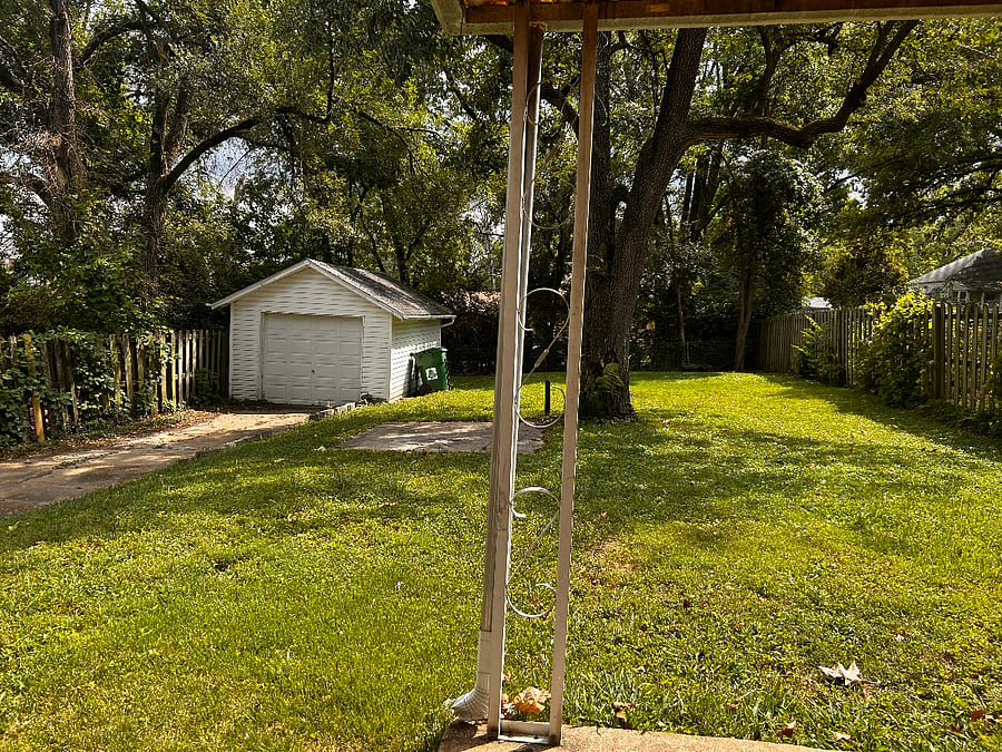 1 Car Garage and a Concrete Pad for a Grill Under the Tree