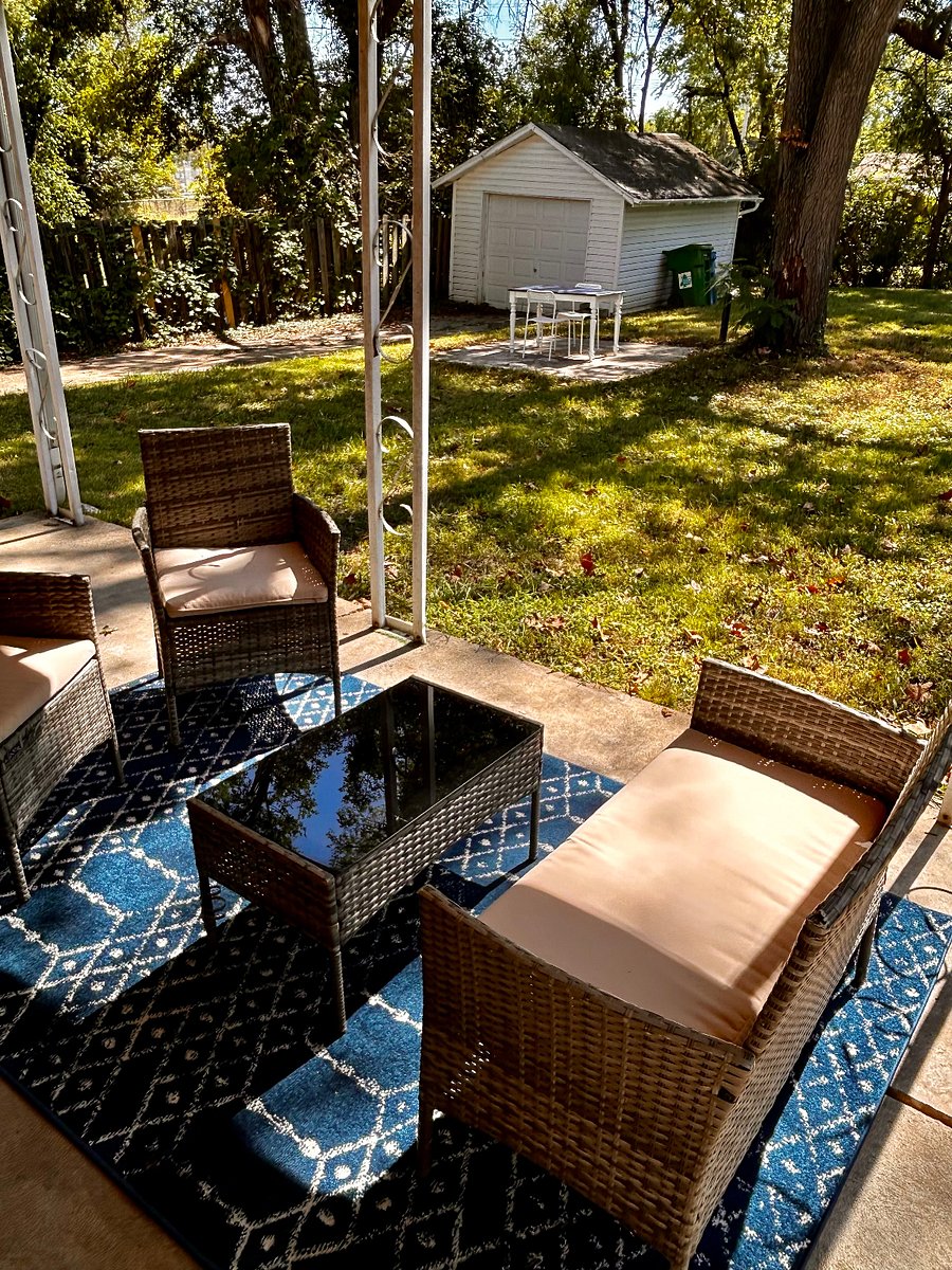 Fenced Backyard with Garage and Seating Area.