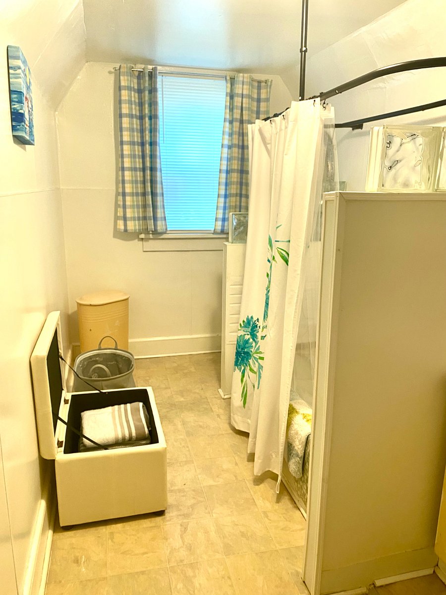 Large bathroom with hand shower.