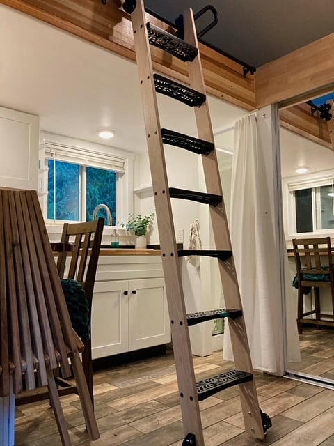 Handsome rolling library ladder provides safe access to the loft and then moves out of the way.
