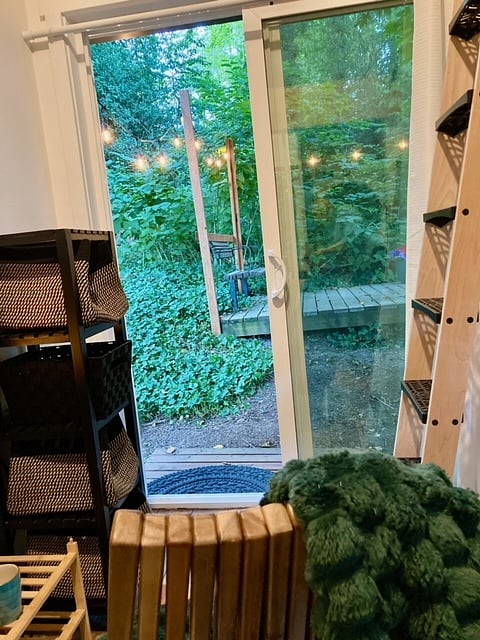 Lounge in the comfy chair in front of the fireplace and enjoy the view of the forest and lights. No other building in sight.