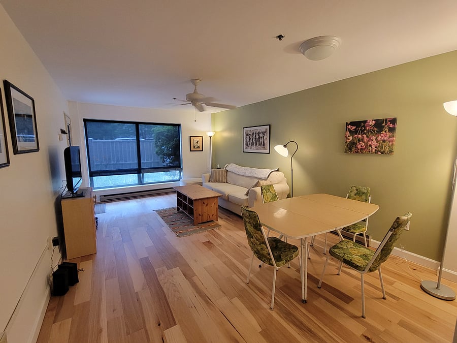 Living/dining area with privacy/darkening shade.