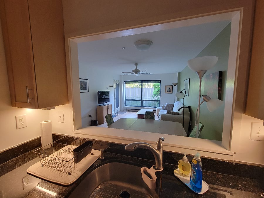 View from kitchen from enlarged pass-through window. Watch TV, entertain guests or just view the garden.