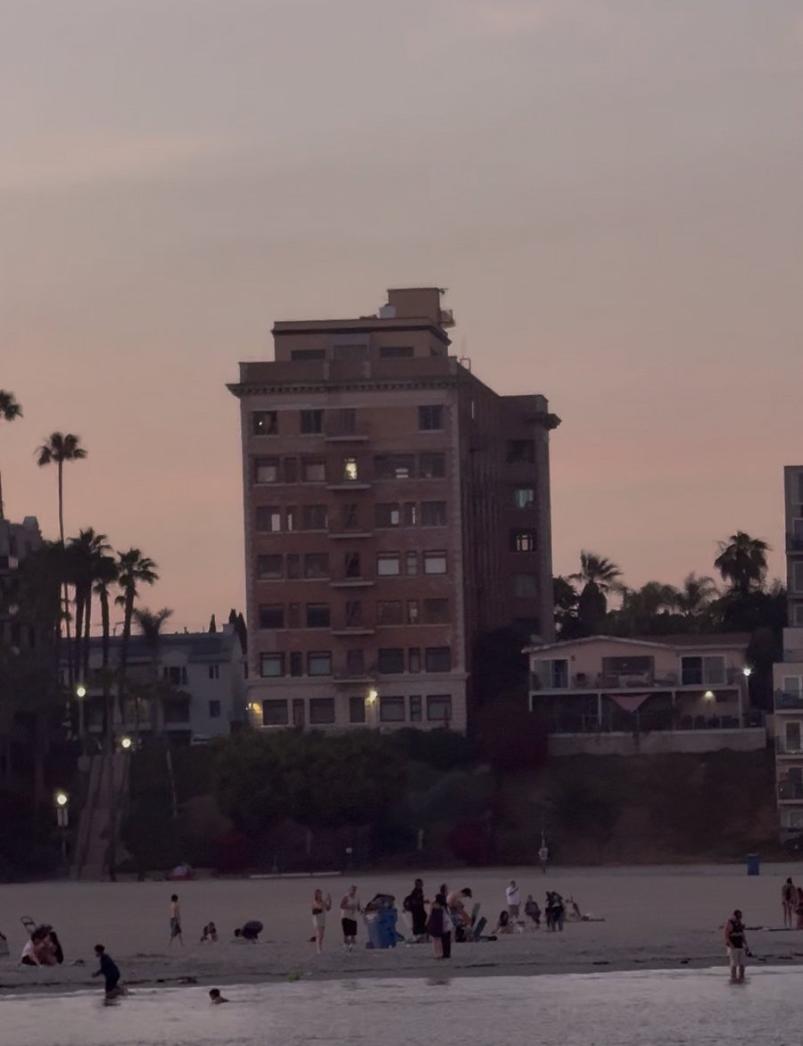 Exterior of building shown from beach / oceanside