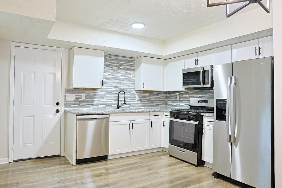 Fully stocked shared kitchen with granite countertops and stainless steel appliances.