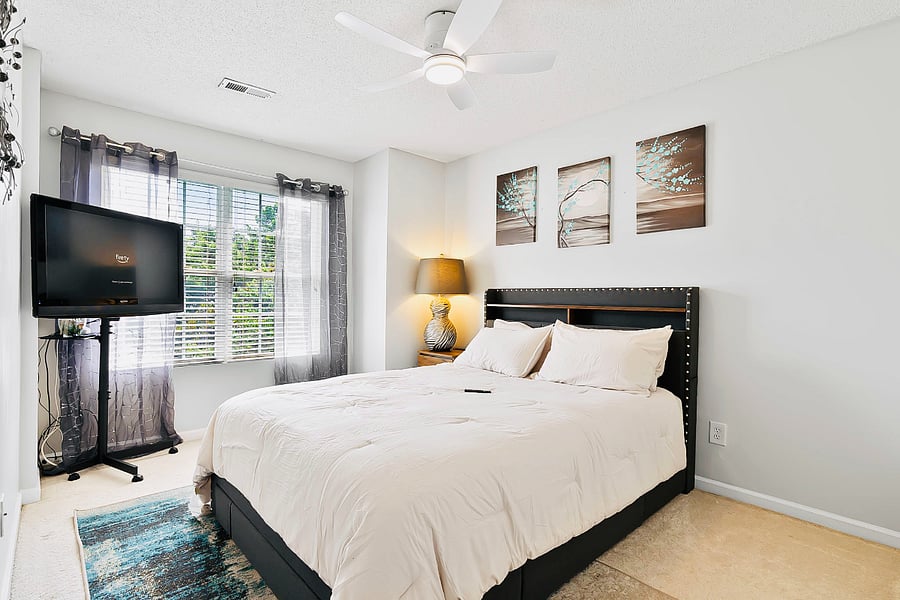Queen bed draped in soft, high-thread-count sheets that feel silky against the skin. 4 fluffy pillows add to the cozy ambiance. The linens are neutral to enhance the elegance & offer relaxation with a 45 inch smart TV equipped with closet & storage.