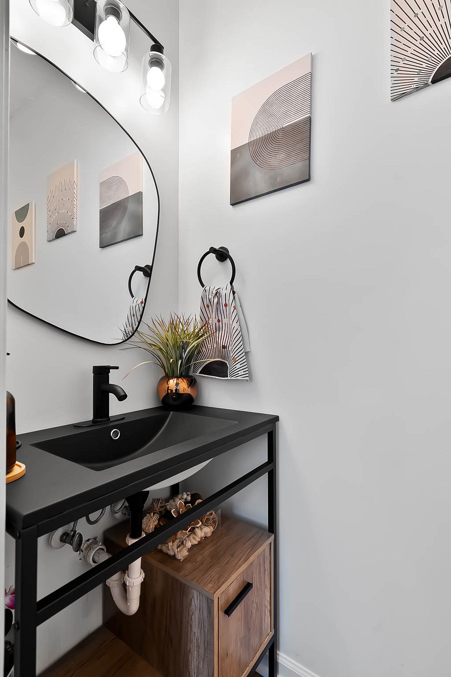 Tucked away right at the front door entryway we have the half bath. Equipped with hand soap, lotion and other cleaning supplies to quickly freshen up .