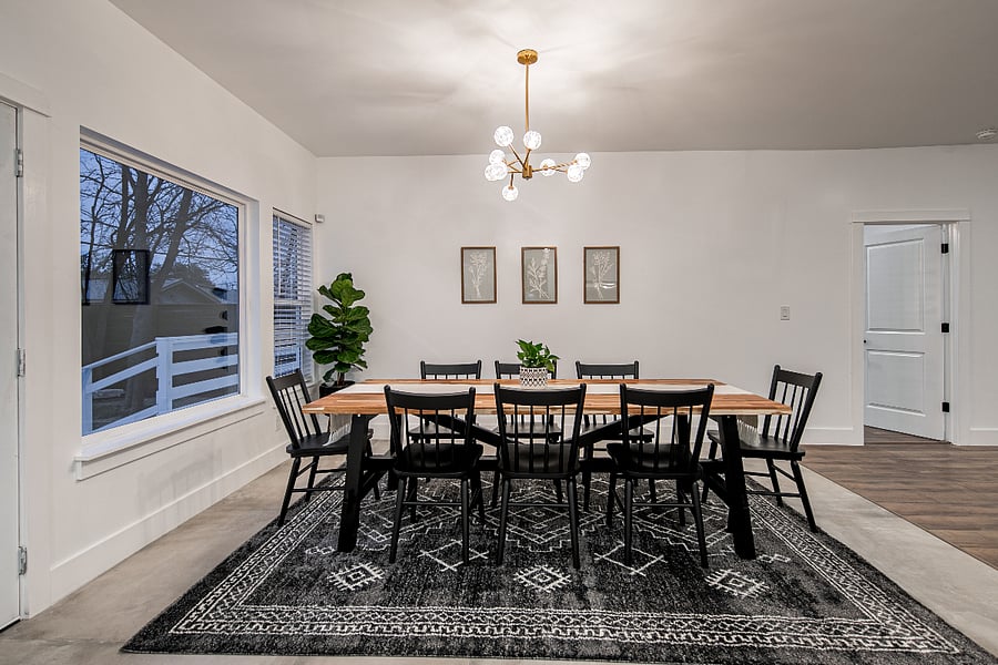 The large dining table over looking the backyard is large plus additional seats at the bar.