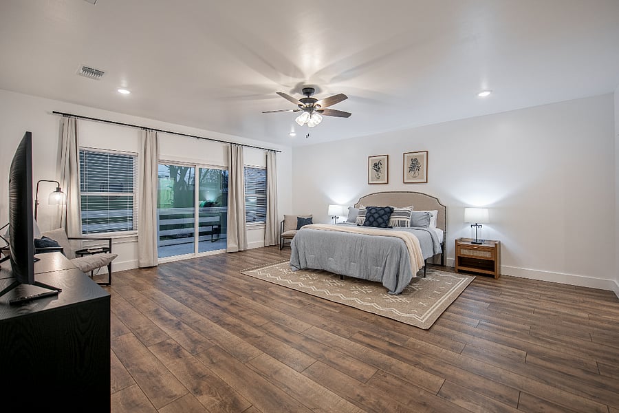 Spread out in the spacious master bedroom. This room features a luxury hybrid king bed, accent chairs, an alarm clock, sound machine, desk, and black out curtins. Hangers and luggage racks are included in the closet.