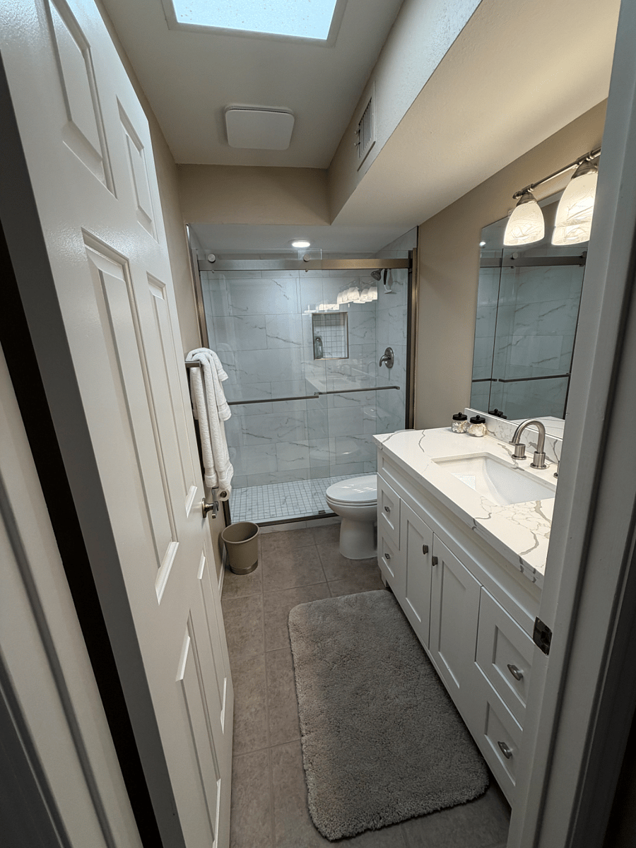 SECOND BATHROOM. WALK - IN SHOWER AND QUARTZ COUNTER TOP WITH UNDERMOUNT SINK.