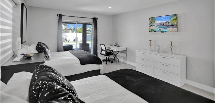 Black & White Bedroom , 2 Queens Size Beds , Desk and sliding door to backyards Pool area