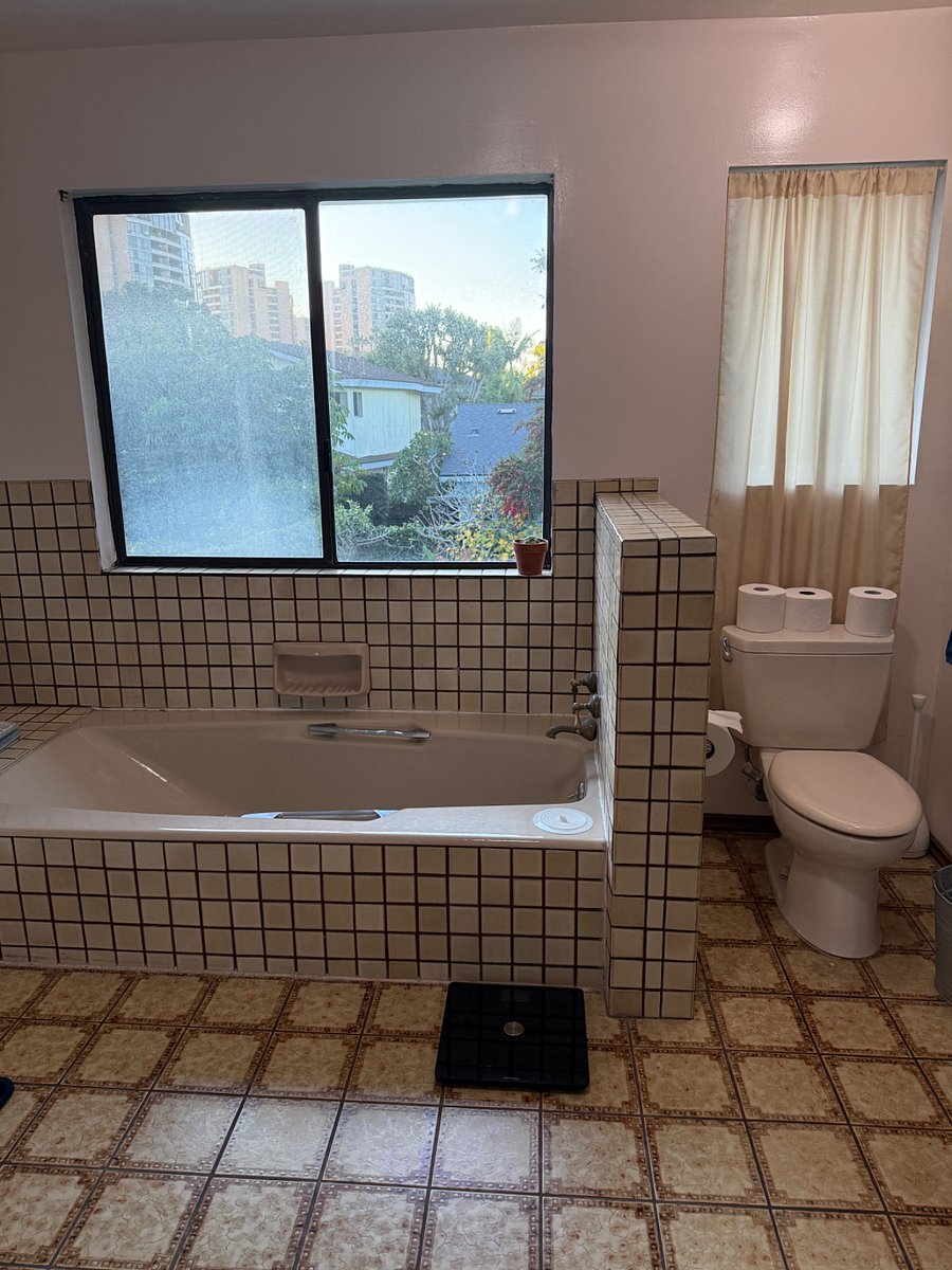 full bathroom with double sinks, bathtub and stand up shower.