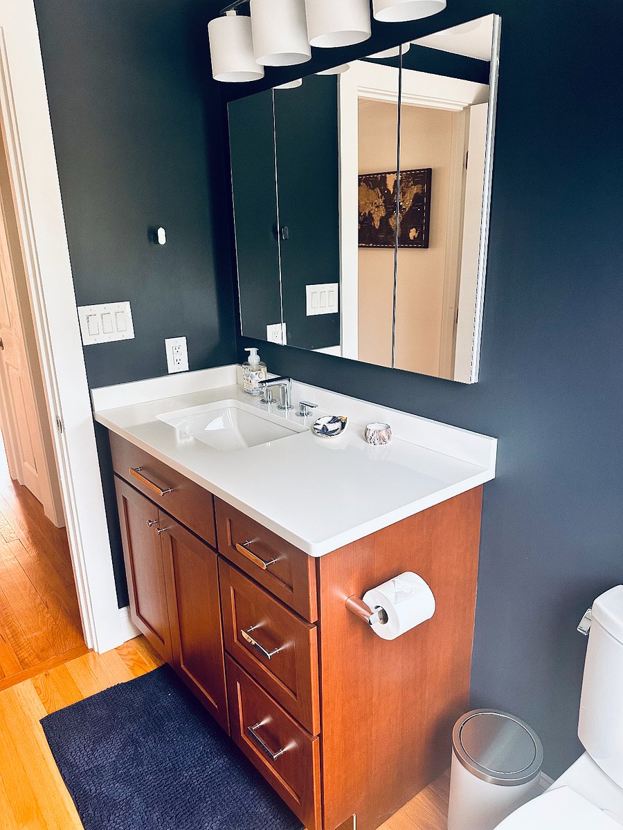 Half bath with vanity cabinet and mirror
